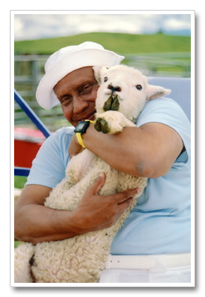 Sri Chinmoy holding a lamb