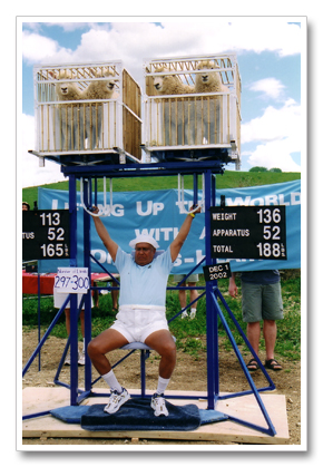 Sri Chinmoy lifting lambs